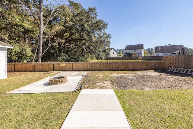 view of yard with a patio and an outdoor fire pit