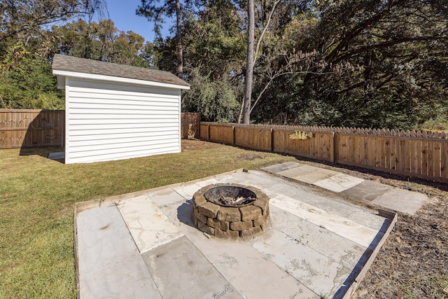 view of patio with a fire pit and a storage unit