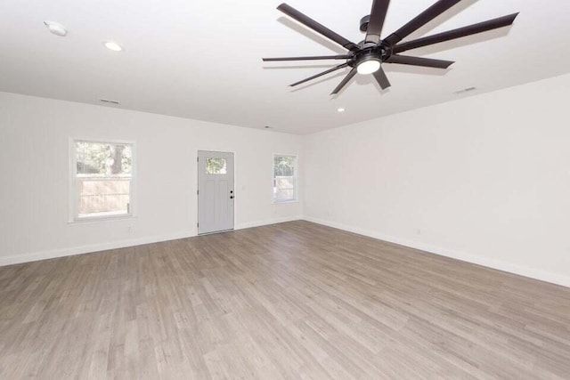 unfurnished living room featuring ceiling fan and light hardwood / wood-style floors