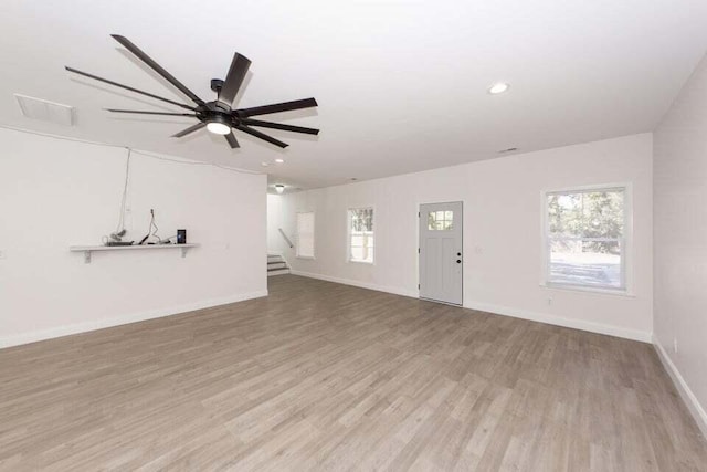 unfurnished living room featuring light wood-type flooring and ceiling fan