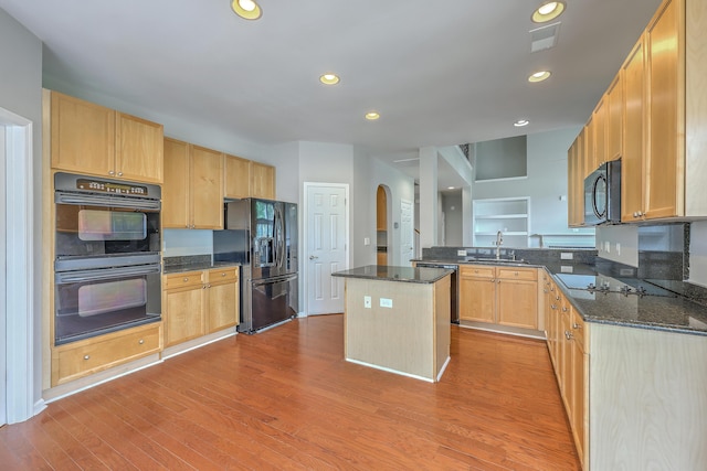 9379 Harroway Rd, Summerville, SC 29485 - kitchen featuring a sink, black appliances, light brown cabinetry, arched walkways, and visible vents