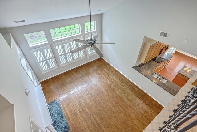 9379 Harroway Rd, Summerville, SC 29485 - unfurnished living room with a ceiling fan, wood finished floors, a sink, baseboards, and visible vents