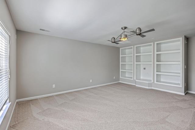 9379 Harroway Rd, Summerville, SC 29485 - carpeted spare room featuring ceiling fan, baseboards, built in features, and visible vents