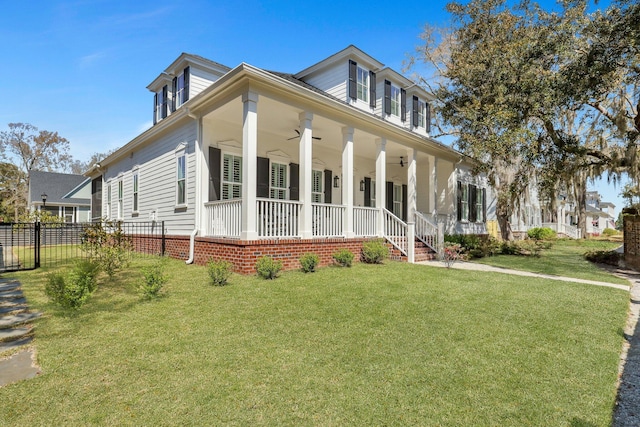 view of front of property with a porch, a front yard, and fence