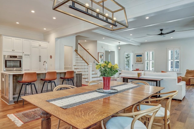 dining space featuring stairway, ornamental molding, recessed lighting, light wood-style floors, and a ceiling fan