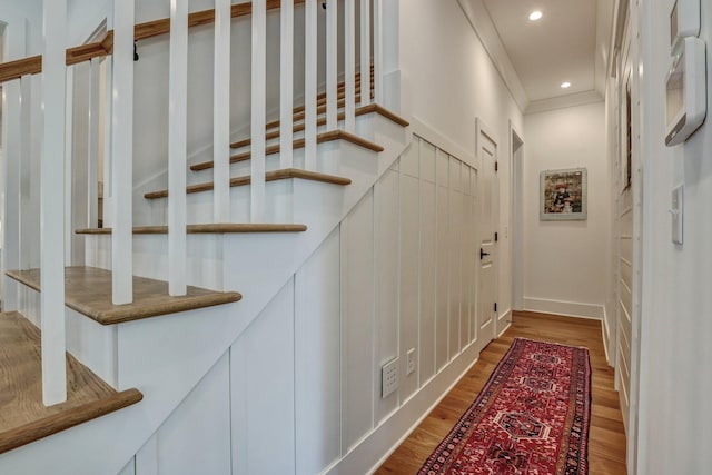 hall with recessed lighting, crown molding, and wood finished floors