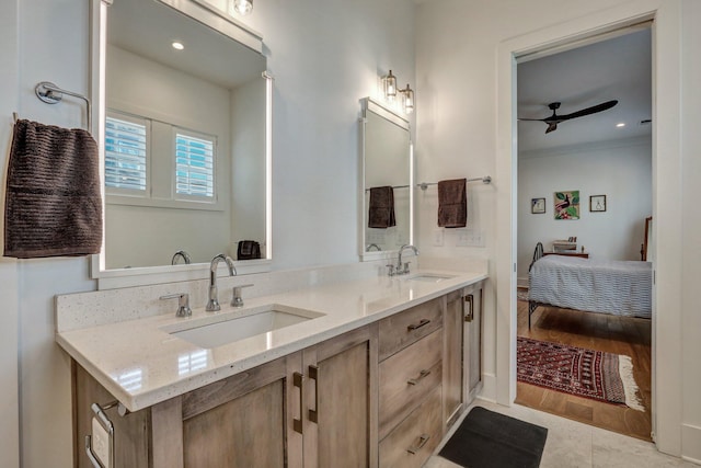 bathroom featuring double vanity, a ceiling fan, ensuite bathroom, and a sink