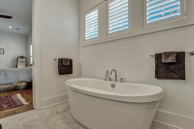 full bathroom with a freestanding tub, visible vents, ornamental molding, ensuite bathroom, and baseboards