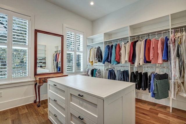 walk in closet with wood finished floors