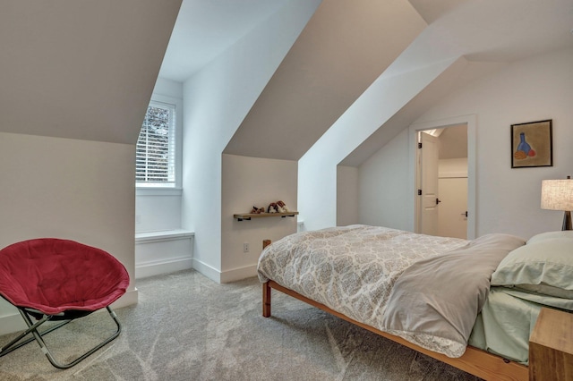 bedroom with lofted ceiling and baseboards