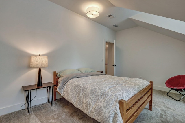 carpeted bedroom with visible vents, baseboards, and vaulted ceiling