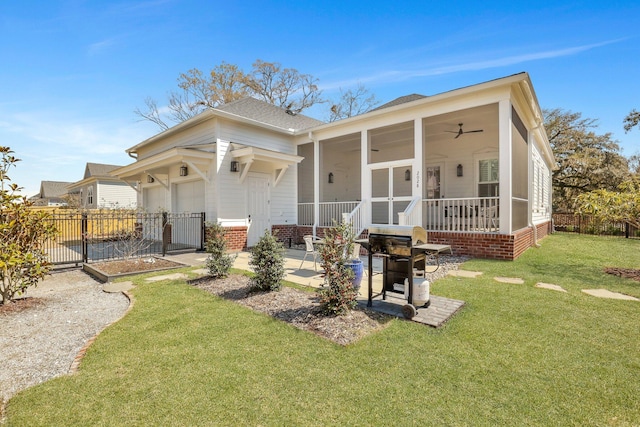 back of house with a sunroom, a lawn, ceiling fan, and fence