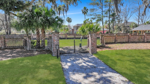 view of gate featuring a lawn and fence private yard