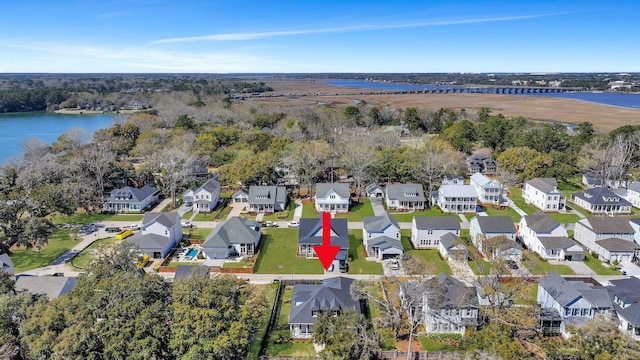 drone / aerial view with a water view and a residential view