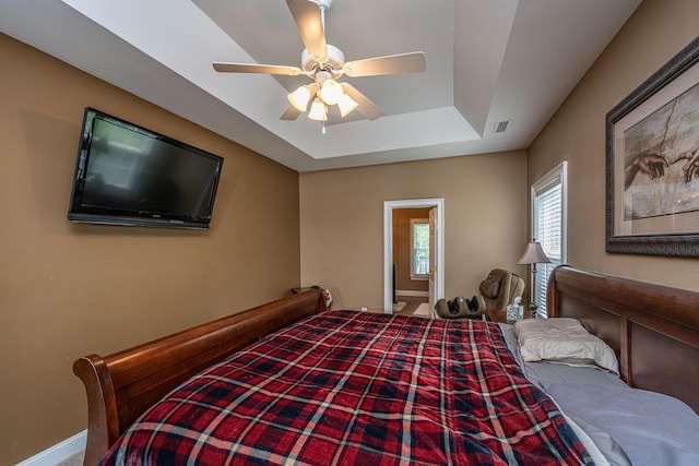 1409 Bloomingdale Ln, Mount Pleasant, SC 29466 - bedroom with baseboards, a tray ceiling, and ceiling fan