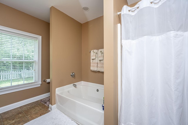 1409 Bloomingdale Ln, Mount Pleasant, SC 29466 - bathroom with baseboards, a bath, and curtained shower