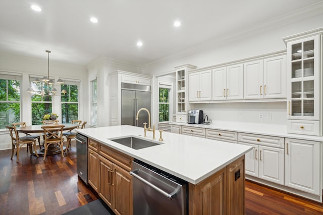 kitchen featuring white cabinetry, sink, an island with sink, and appliances with stainless steel finishes