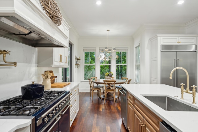 kitchen featuring white cabinetry, sink, custom exhaust hood, high end appliances, and light stone counters