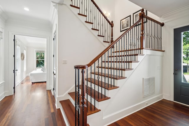 foyer with crown molding and dark hardwood / wood-style flooring