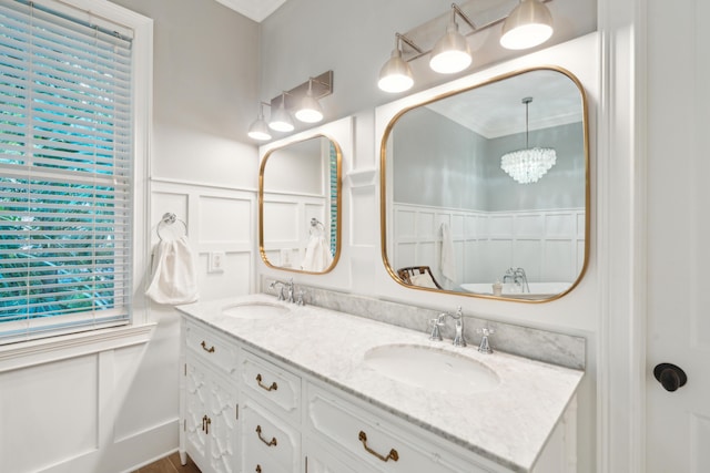 bathroom with crown molding and vanity