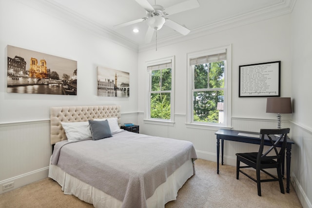 carpeted bedroom with ornamental molding and ceiling fan