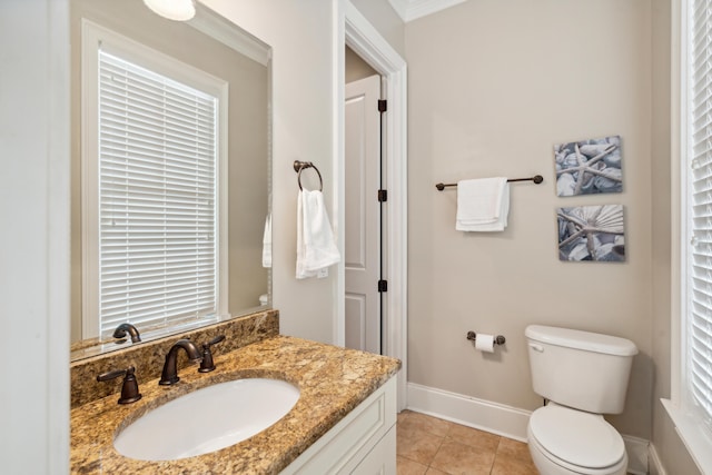 bathroom with vanity, ornamental molding, tile patterned floors, and toilet