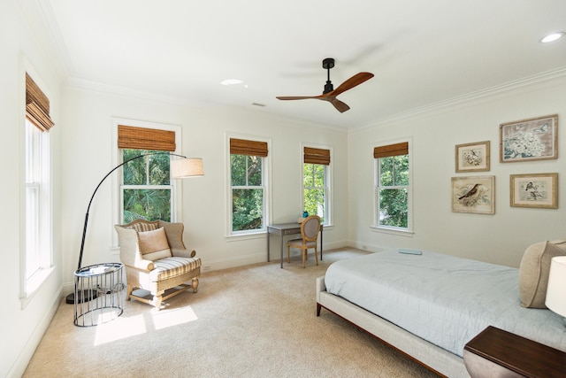 bedroom with multiple windows, ceiling fan, and light carpet