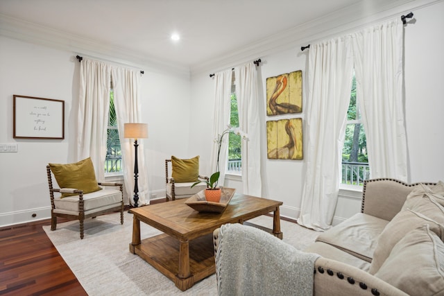 sitting room with dark wood-type flooring and crown molding