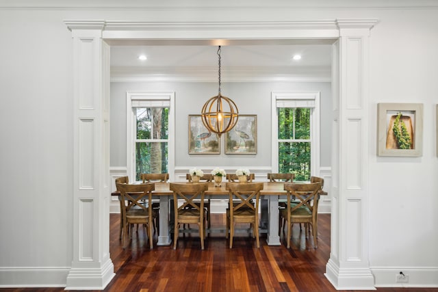 dining area with decorative columns, crown molding, dark hardwood / wood-style floors, and a wealth of natural light