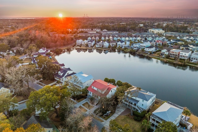 drone / aerial view with a water view and a residential view