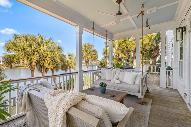 sunroom / solarium featuring a water view and ceiling fan