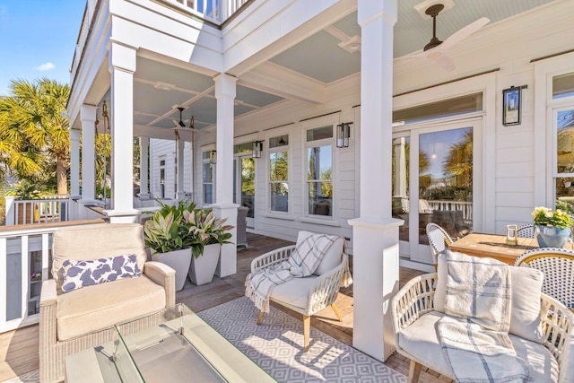 wooden terrace with ceiling fan and a porch