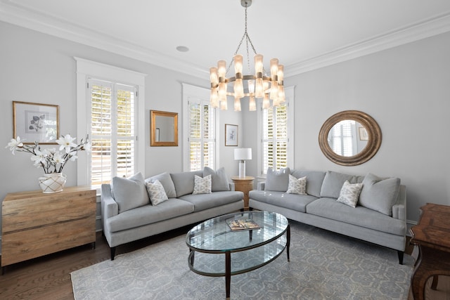 living room featuring a chandelier, crown molding, and wood finished floors