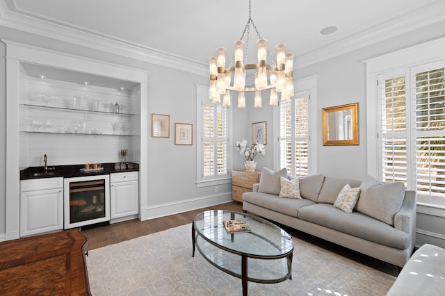 living area with beverage cooler, dark wood-type flooring, baseboards, ornamental molding, and indoor wet bar