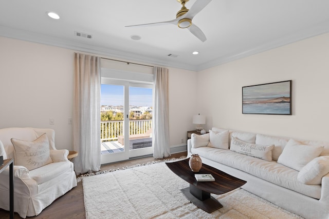 living area featuring crown molding, visible vents, wood finished floors, and recessed lighting