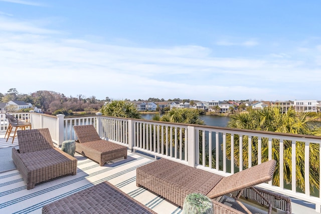 wooden terrace featuring a water view and a residential view