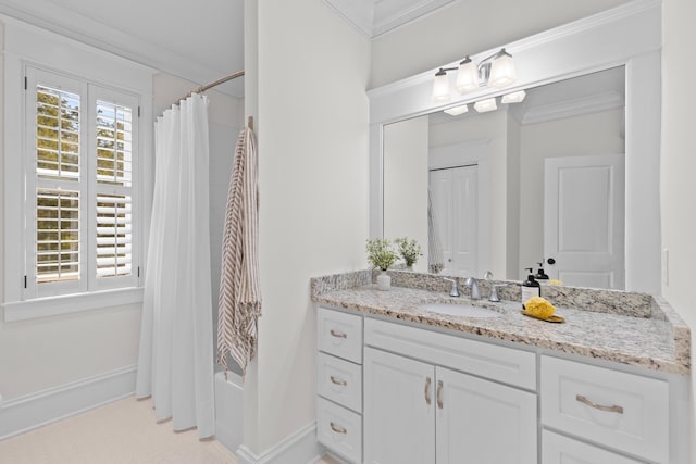 bathroom featuring baseboards, a shower with curtain, vanity, and crown molding