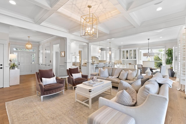 living room featuring beam ceiling, coffered ceiling, and crown molding