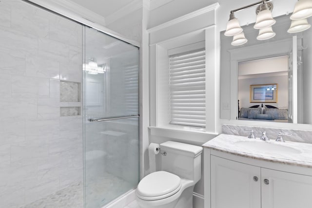 full bath featuring toilet, vanity, a shower stall, ensuite bath, and crown molding