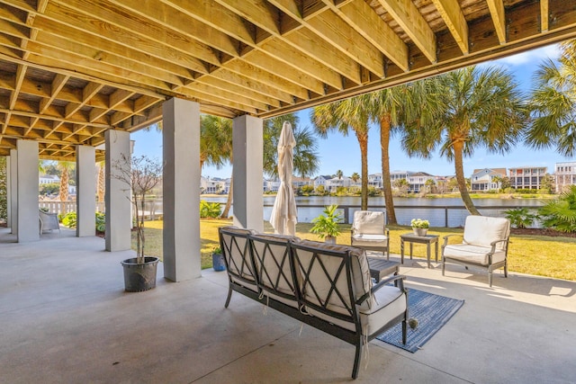 view of patio with a residential view and a water view