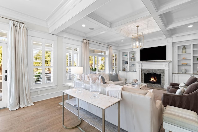 living room with beamed ceiling, a fireplace, coffered ceiling, and crown molding