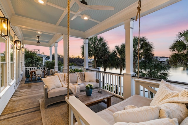 wooden deck with an outdoor living space, outdoor dining space, and a ceiling fan