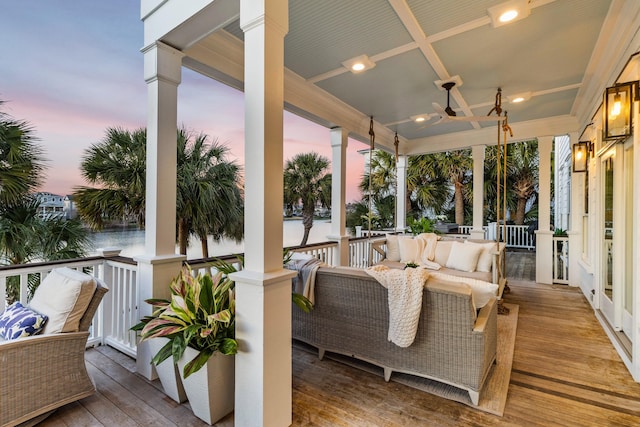 deck with ceiling fan and a porch