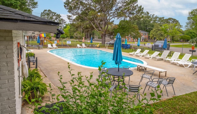 community pool with fence and a patio