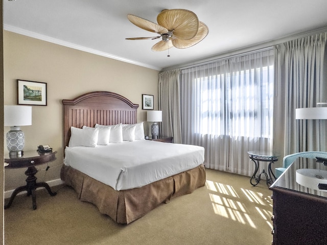 bedroom with baseboards, ceiling fan, ornamental molding, and carpet flooring