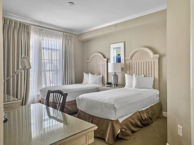 bedroom with carpet flooring and crown molding