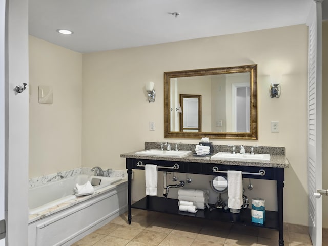 bathroom with tile patterned flooring, double vanity, a sink, and a bath