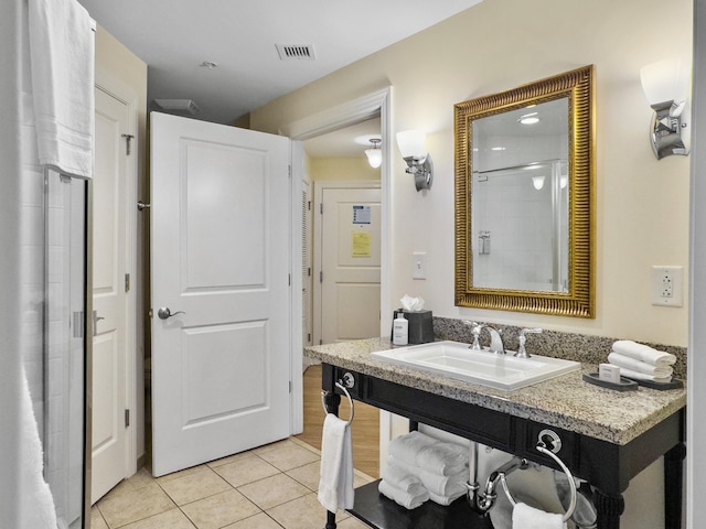 full bathroom with a shower, a sink, visible vents, and tile patterned floors