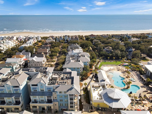 birds eye view of property with a water view and a view of the beach