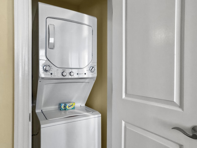 laundry area with stacked washer and dryer and laundry area